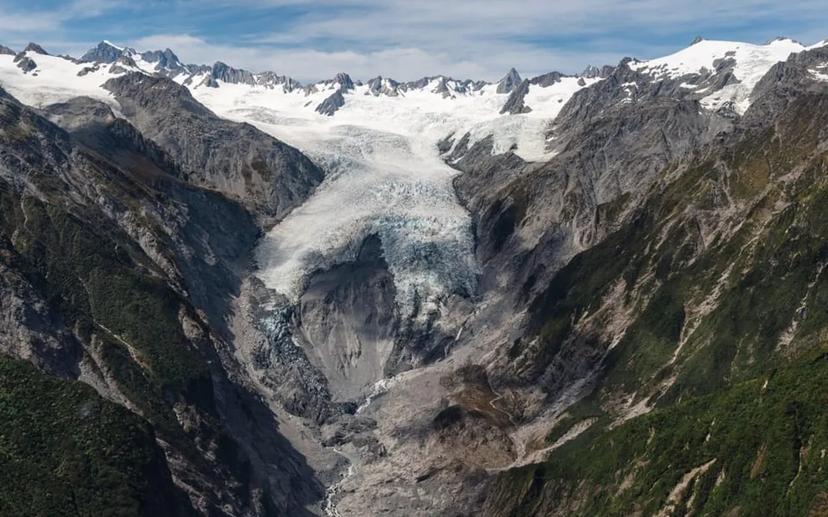 A Fox Glacier helicopter on the snowfield, photographed for a scenic flight listing