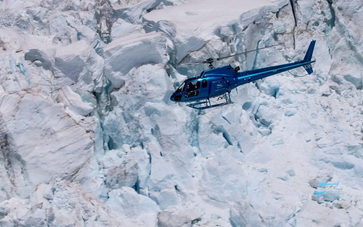 A helicopter over Fox Glacier and the Southern Alps